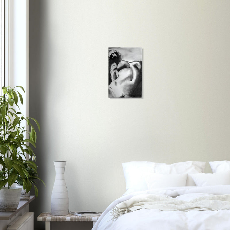Minimalist bedroom with abstract black and white nude artwork above white bed and green plant by window