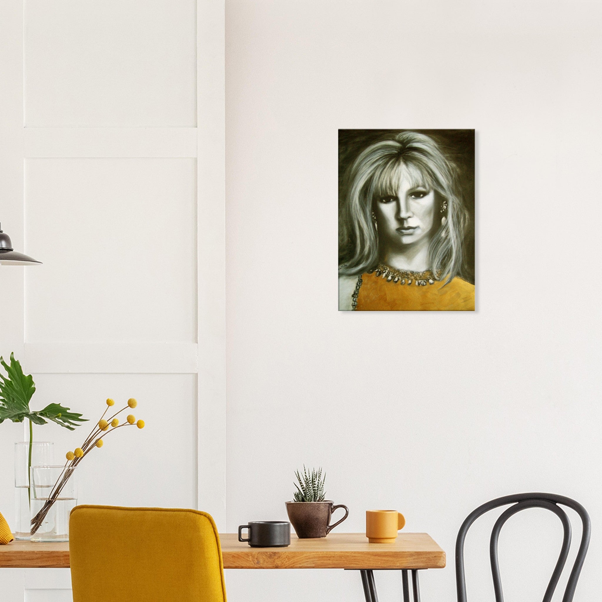 Modern dining room with wooden table, yellow chair, black chair, potted plants, and portrait painting on white wall