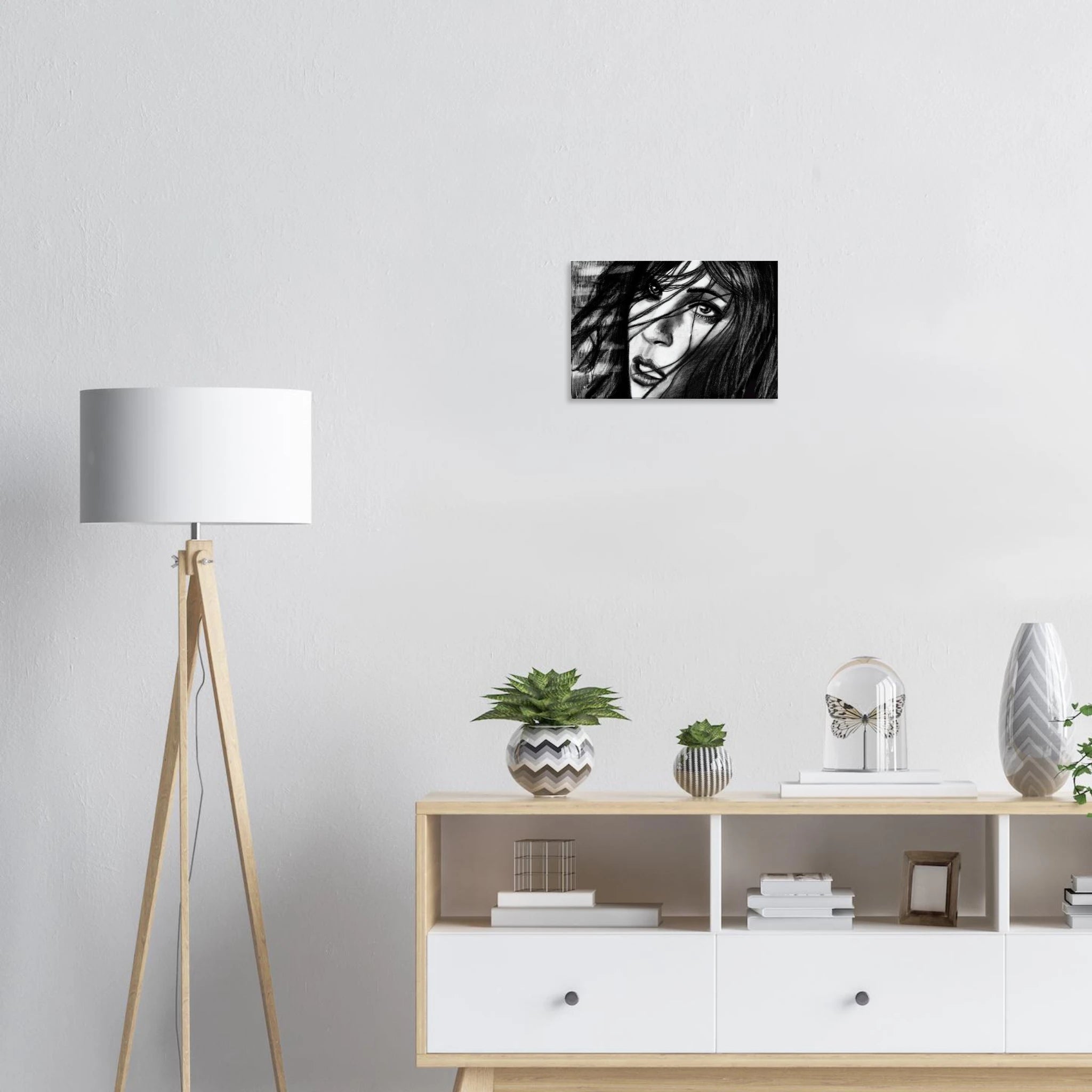 Modern interior with wooden floor lamp, white sideboard, plants, and black-and-white portrait artwork