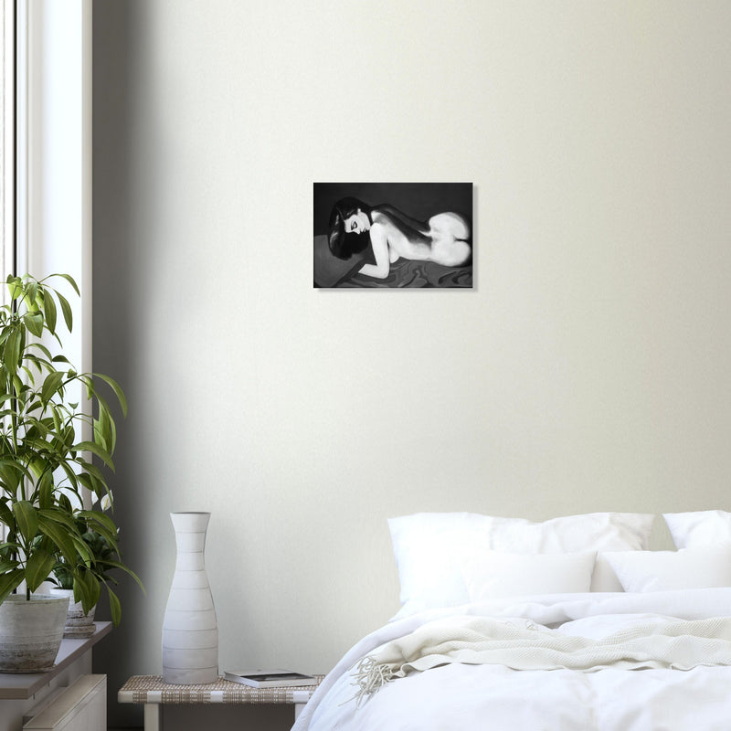 Black and white painting of a nude woman lying on her side, displayed in a minimalist bedroom