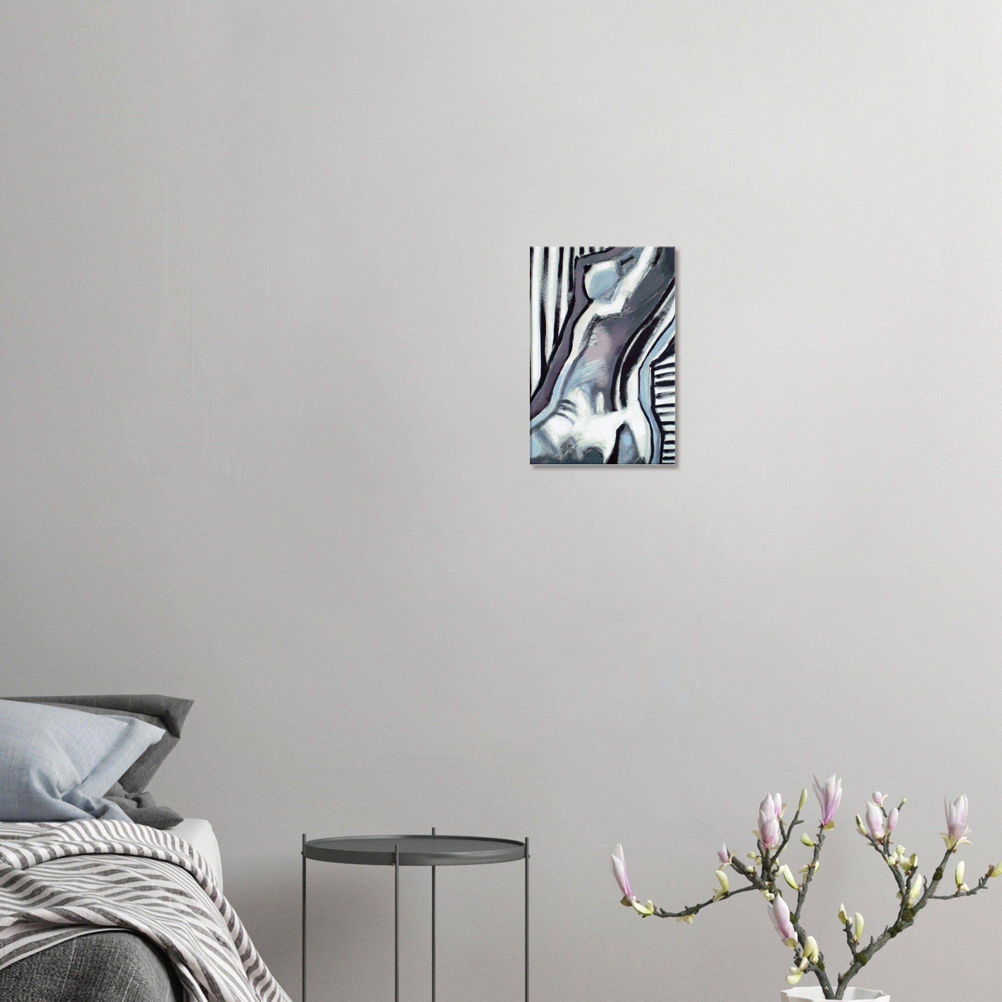 Modern abstract painting of a nude figure on white wall above minimal black side table and bed