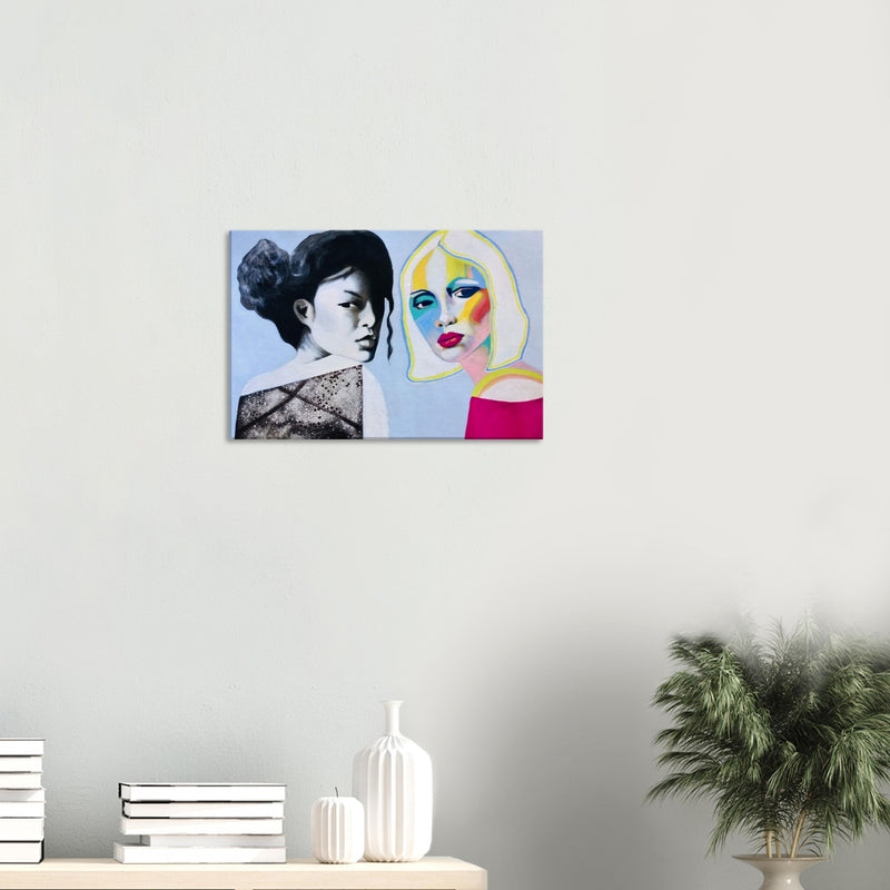 Contemporary wall art featuring two women, one black and white and one colorful, in a minimal room with plants and books