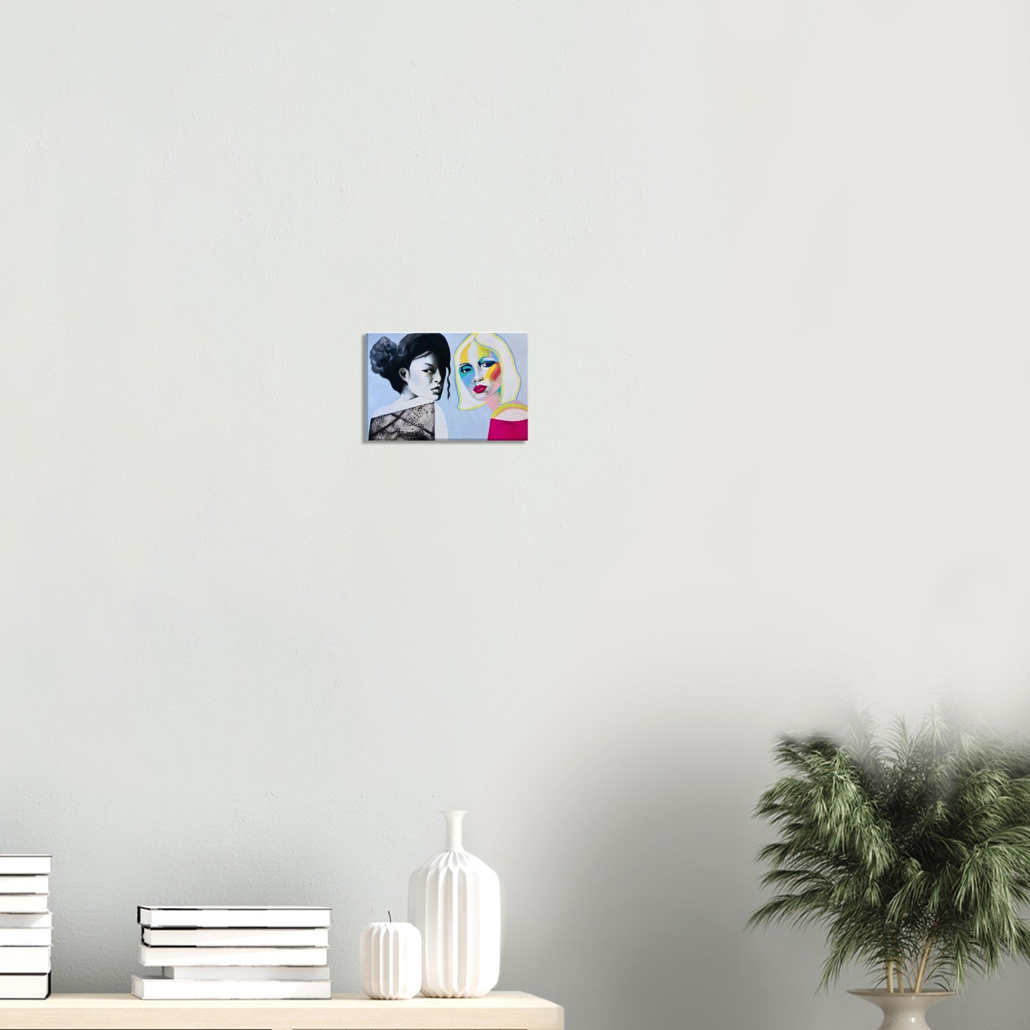 Modern wall art featuring two women portraits in black and white and vibrant colors, hung above minimalist decor