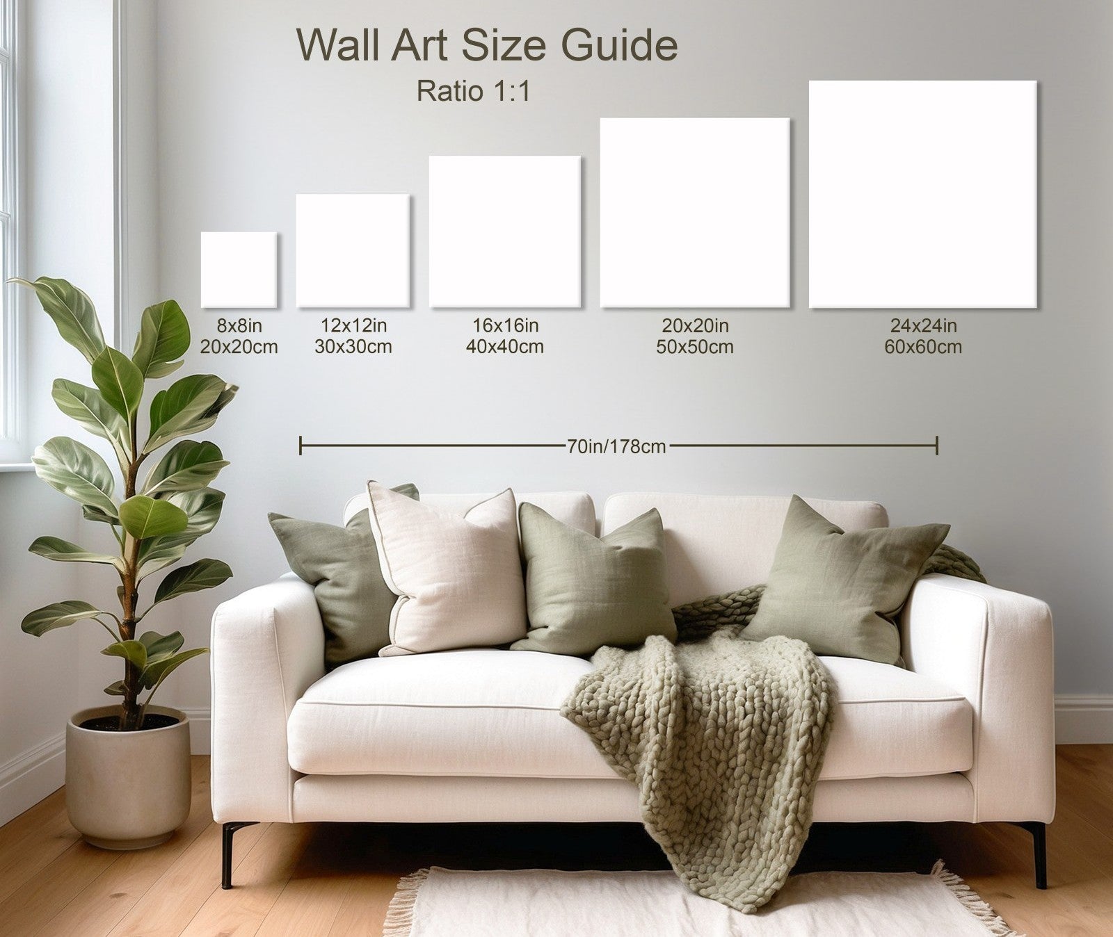 Living room with white sofa, green pillows, knitted throw, potted plant, and wall art size guide chart above sofa.